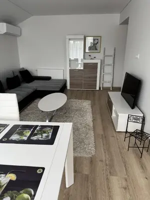 a living room with a couch and a table at Florina namai in Marijampolė