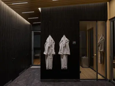 three shirts hanging on a wall in a hallway at Vilkiškių Karpis Glamping in Vilionys