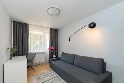 a living room with a couch and a window at 2-BD Apartment Winery by Polo Apartments in Kaunas