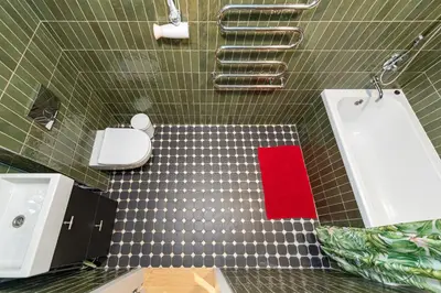 a bathroom with a white sink and a red towel at 2-BD Apartment Winery by Polo Apartments in Kaunas