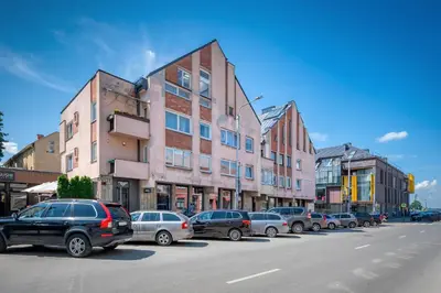 a row of cars parked in a parking lot next to buildings at 2-BD Apartment Winery by Polo Apartments in Kaunas