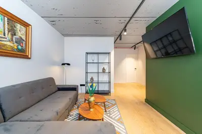 a living room with a couch and a table at 2-BD Apartment Winery by Polo Apartments in Kaunas