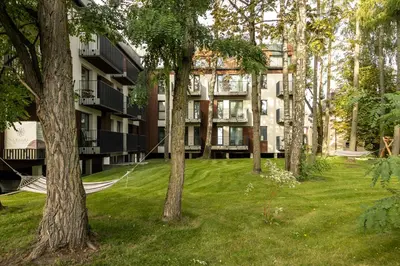 an apartment building with a yard with trees at Jaukus poilsis Birštone in Birštonas