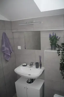 a bathroom with a sink and a mirror at Central Kaunas Apartment in Kaunas