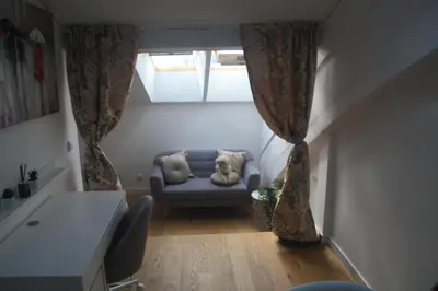 a small living room with a couch and a window at Central Kaunas Apartment in Kaunas
