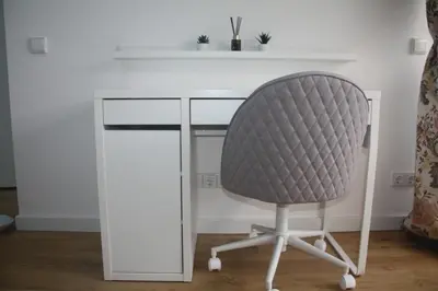 a white desk with a gray chair sitting at it at Central Kaunas Apartment in Kaunas