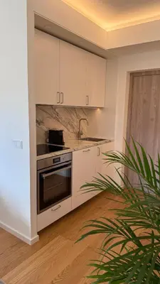 a kitchen with white cabinets and a stove at Algirdo Sunlight Studio in Vilnius