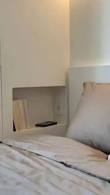 a bed in a white room with a bed sidx sidx at Algirdo Sunlight Studio in Vilnius
