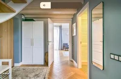 a room with blue walls and a hallway with a mirror at Urban Loft Escape Kaunas Center in Kaunas