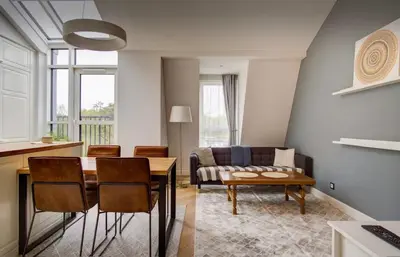 a living room with a table and a couch at Urban Loft Escape Kaunas Center in Kaunas