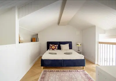 a bedroom with a large bed in a attic at Urban Loft Escape Kaunas Center in Kaunas