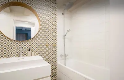 a bathroom with a mirror and a tub and a sink at Urban Loft Escape Kaunas Center in Kaunas