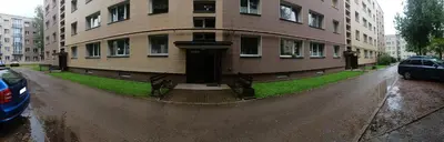 a building with a water fountain in front of it at Gimnazijos apartamentai in Biržai