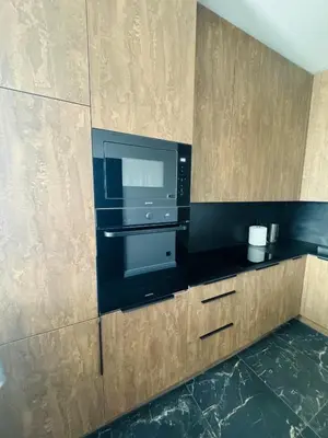 a kitchen with a stove and a microwave at Studija 17 rooms II in Kaunas