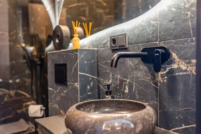 a bathroom with a sink with a faucet at Studija 17 rooms II in Kaunas