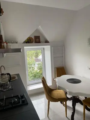 a kitchen with a table and chairs and a window at Privatus Apartamentai Akademijoje in Akademija