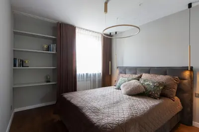 a bedroom with a bed with a large window at French Park View Apartment in Vilnius