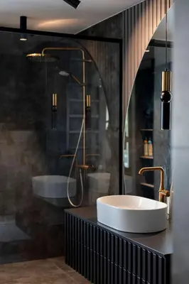 a bathroom with a tub and a sink and a mirror at French Park View Apartment in Vilnius