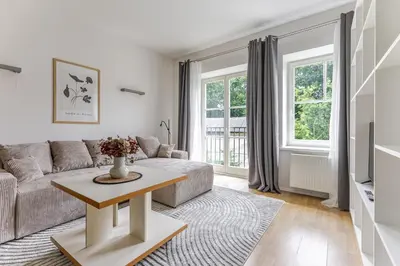 a living room with a couch and a table at Barbacan by Monto in Vilnius