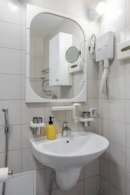 a bathroom with a white sink and a mirror at Barbacan by Monto in Vilnius
