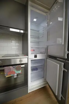 an empty refrigerator with its door open in a kitchen at KgB - 32, Stylish City Apartment - 10 mins walk to Old Town in Vilnius