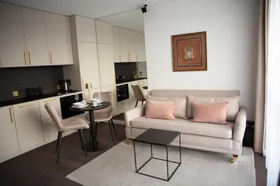 a living room with a couch and a table at Brand new luxurious apartment in Vilnius center in Vilnius