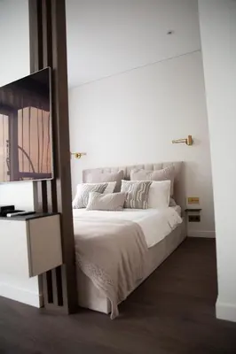 a bedroom with a large white bed with a mirror at Brand new luxurious apartment in Vilnius center in Vilnius