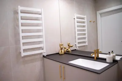 a bathroom with a sink and a mirror at Brand new luxurious apartment in Vilnius center in Vilnius