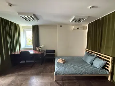 a bedroom with a bed and a desk and a desk at Cozy Seliu 29 in Vilnius