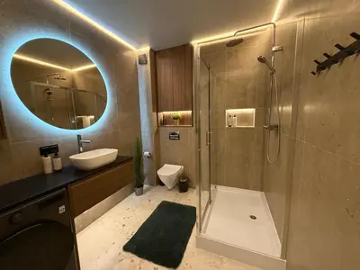 a bathroom with a sink toilet and a mirror at Two bedroom LUXURIOUS Spacios Apartment in Vilnius