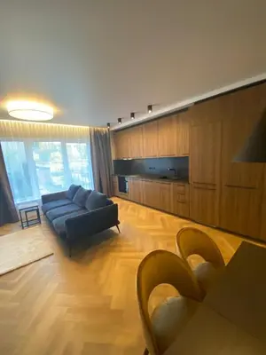 a living room with a couch and a table at Two bedroom LUXURIOUS Spacios Apartment in Vilnius