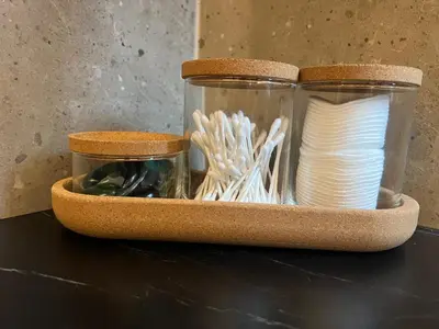 a shelf with two glass jars and spools of thread at Two bedroom LUXURIOUS Spacios Apartment in Vilnius