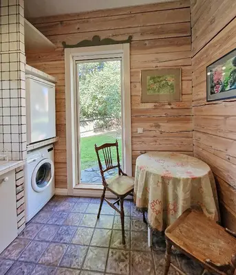 a kitchen with a table and a washing machine at Provance style villa in regional park! in Šilėnai