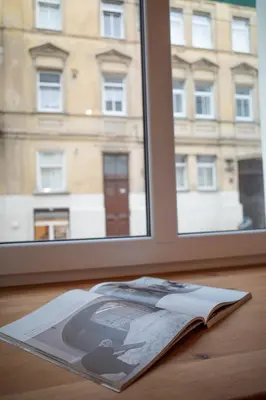 an open book on a table next to a window at Steponas Old Town Studio in Vilnius
