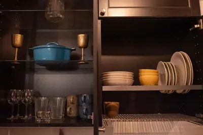 a cabinet filled with plates and bowls and dishes at Steponas Old Town Studio in Vilnius