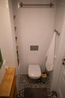 a small bathroom with a toilet in a room at Steponas Old Town Studio in Vilnius