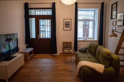 a living room with a couch and a television at Steponas Old Town Studio in Vilnius