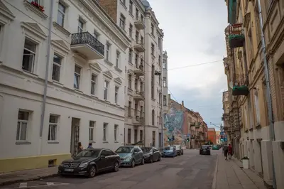 a street with cars parked on the sides of buildings at Steponas Old Town Studio in Vilnius