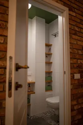 a bathroom with a toilet in a room at Steponas Old Town Studio in Vilnius