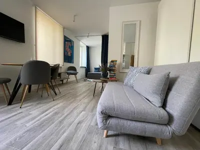 a living room with a couch and a table at Apartment Parko in Molėtai