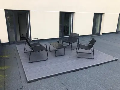 a group of chairs and a table on a patio at Apartment Parko in Molėtai