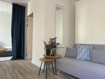 a living room with a couch and a table at Apartment Parko in Molėtai