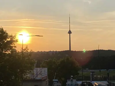 a sunset with a tv tower in the background at VILNIUS apartment with balcony in Vilnius