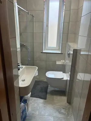 a bathroom with a sink and a toilet and a window at Kaunas Vibes Apartament in Kaunas