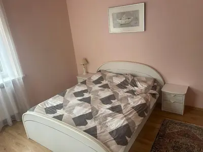 a bedroom with a bed with a quilt on it at Kaunas Vibes Apartament in Kaunas