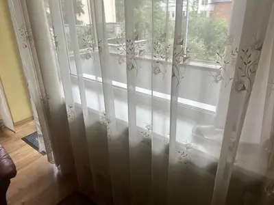 a window with white curtains in a room at Kaunas Vibes Apartament in Kaunas