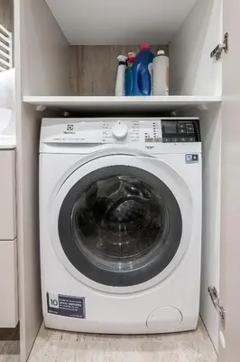 a white washing machine in a small kitchen at Top Floor, Spacious Apartment w-Balcony & Garage I Cohost in Vilnius