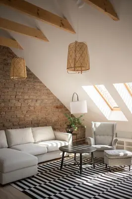 a living room with a white couch and a table at Castle Street Modern Apartments I cohost in Vilnius