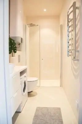 a bathroom with a toilet sink and a shower at Castle Street Modern Apartments I cohost in Vilnius