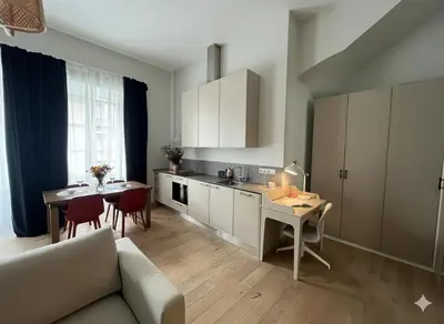 a kitchen with a couch and a table in a room at Castle Street Modern Apartments I cohost in Vilnius